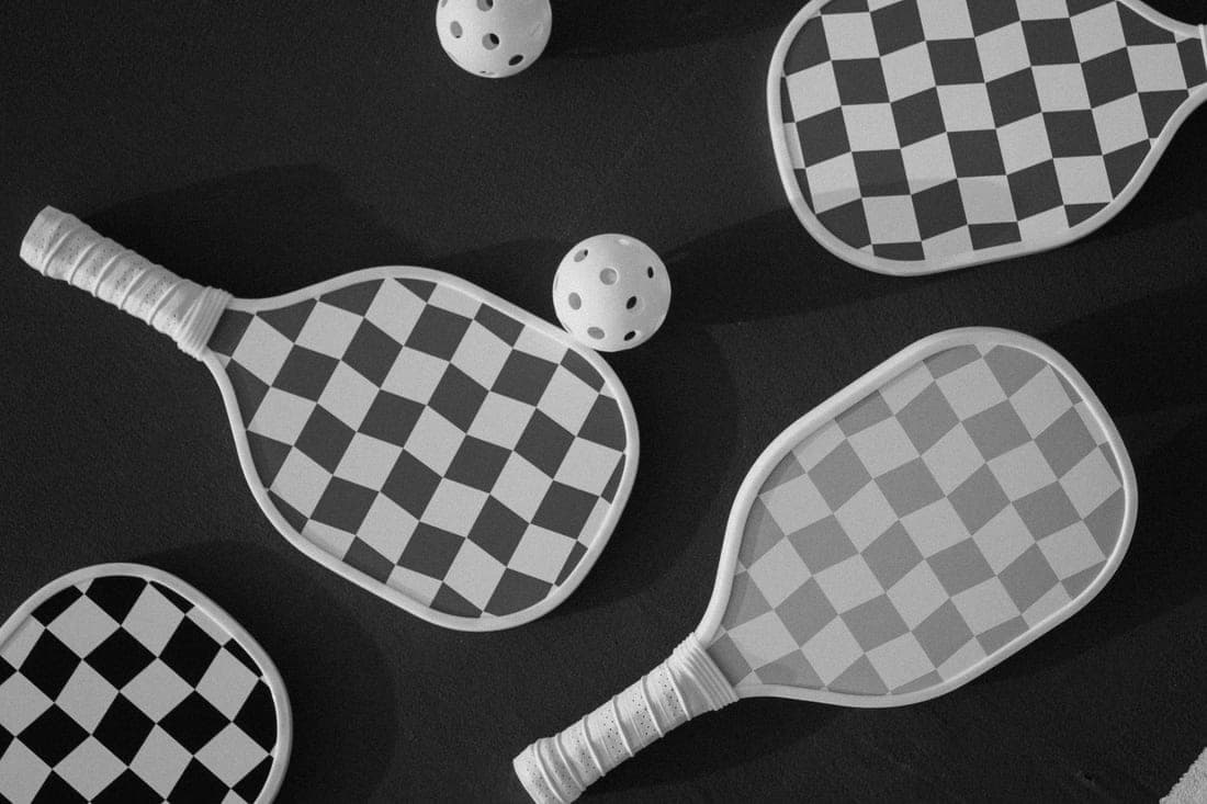 Pickleball paddle face texture photographed in hard side light