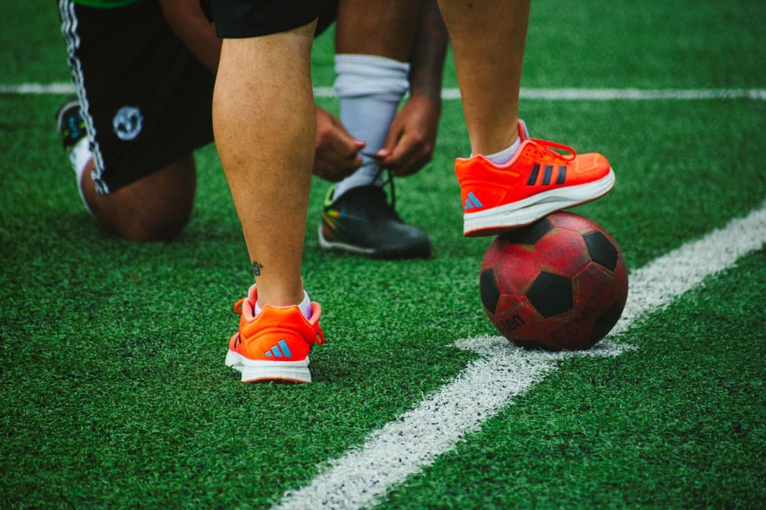Court shoes on the artificial turf surface of a padel court