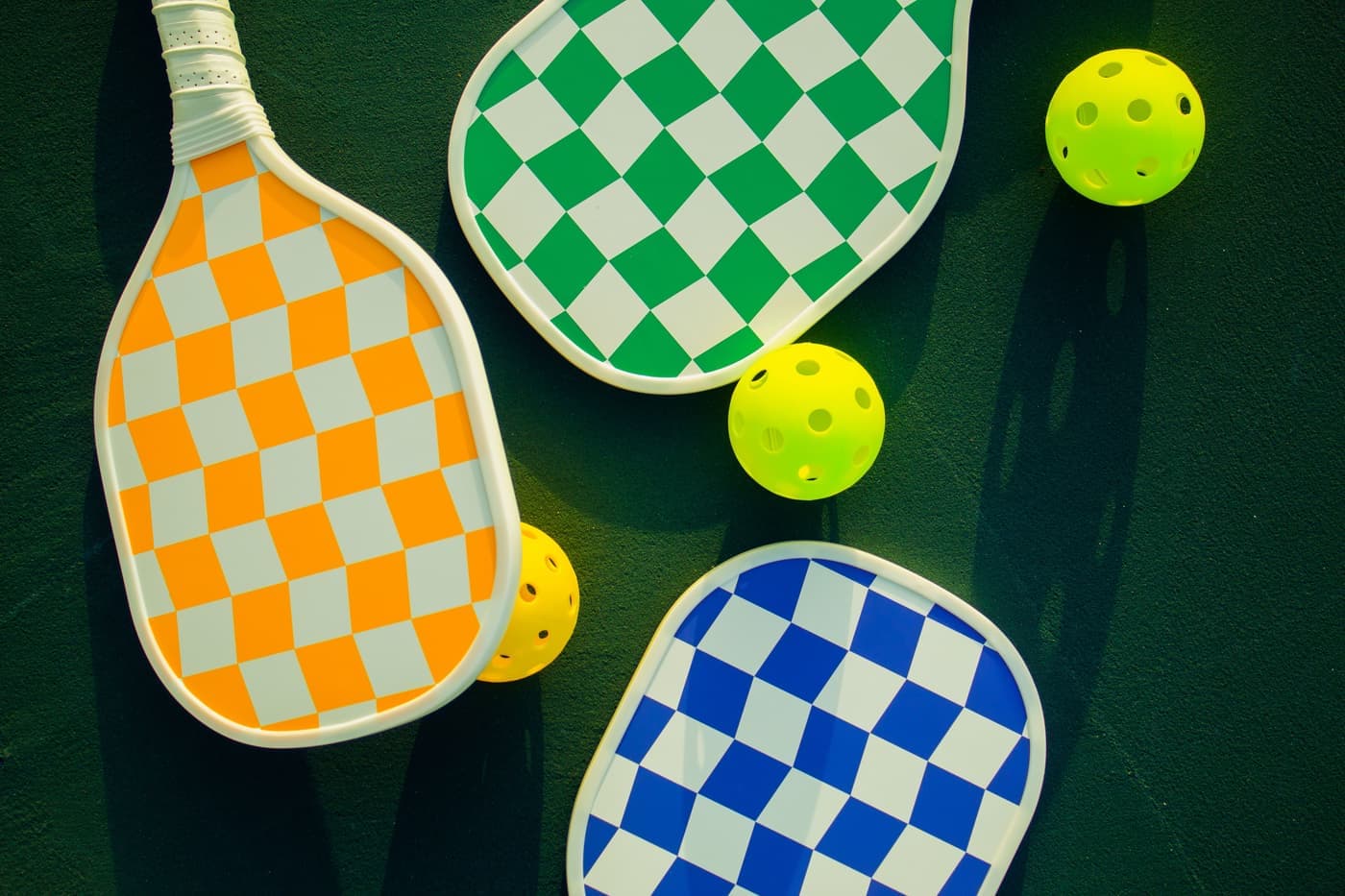 A padel racket and a pickleball paddle placed side by side