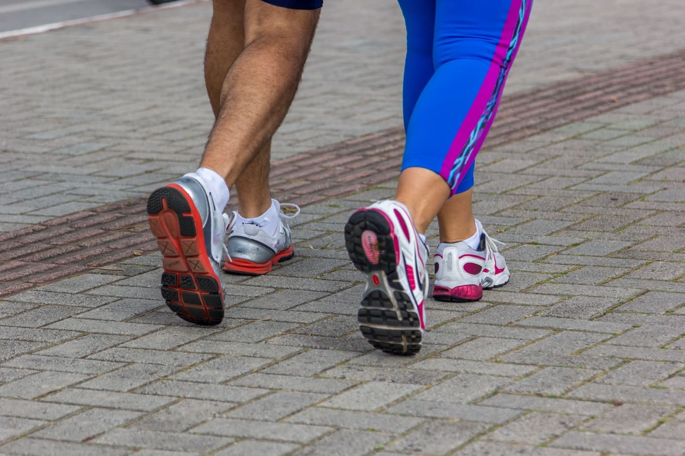 A running shoe and a court shoe placed side by side