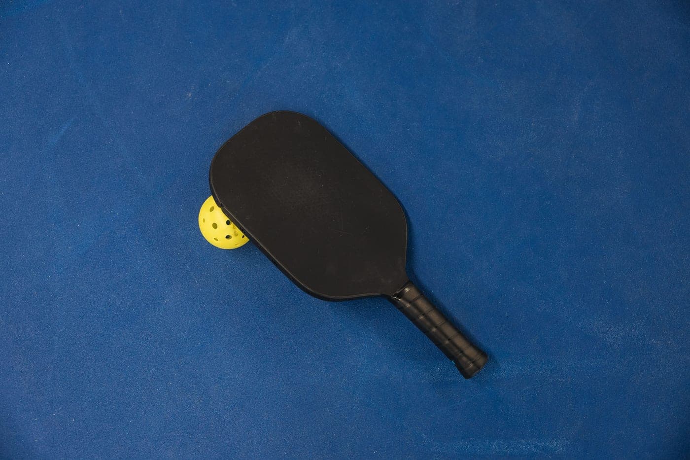 The edge guard and face of a pickleball paddle in close-up