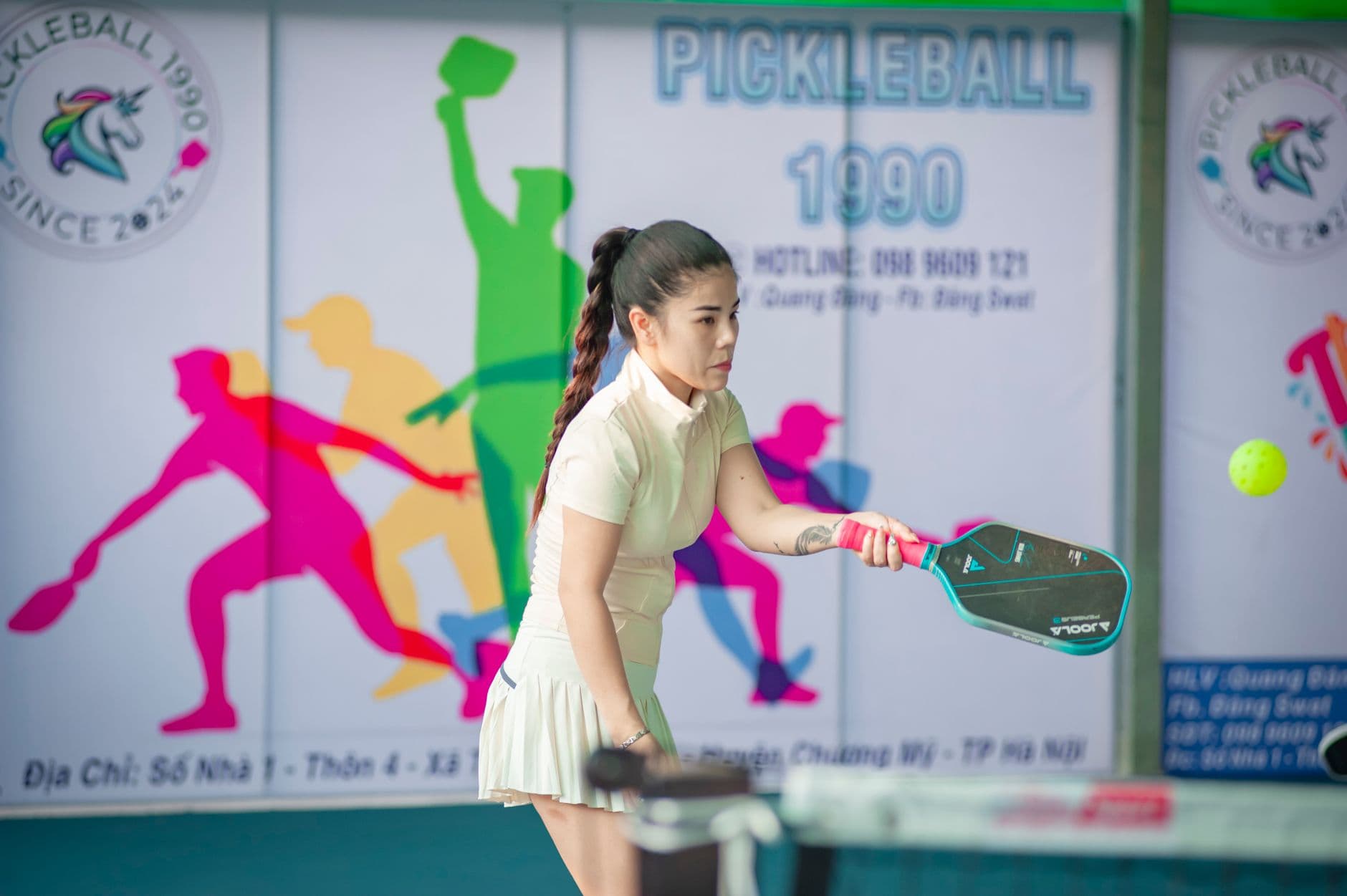 A pickleball player preparing to strike the ball at the kitchen line