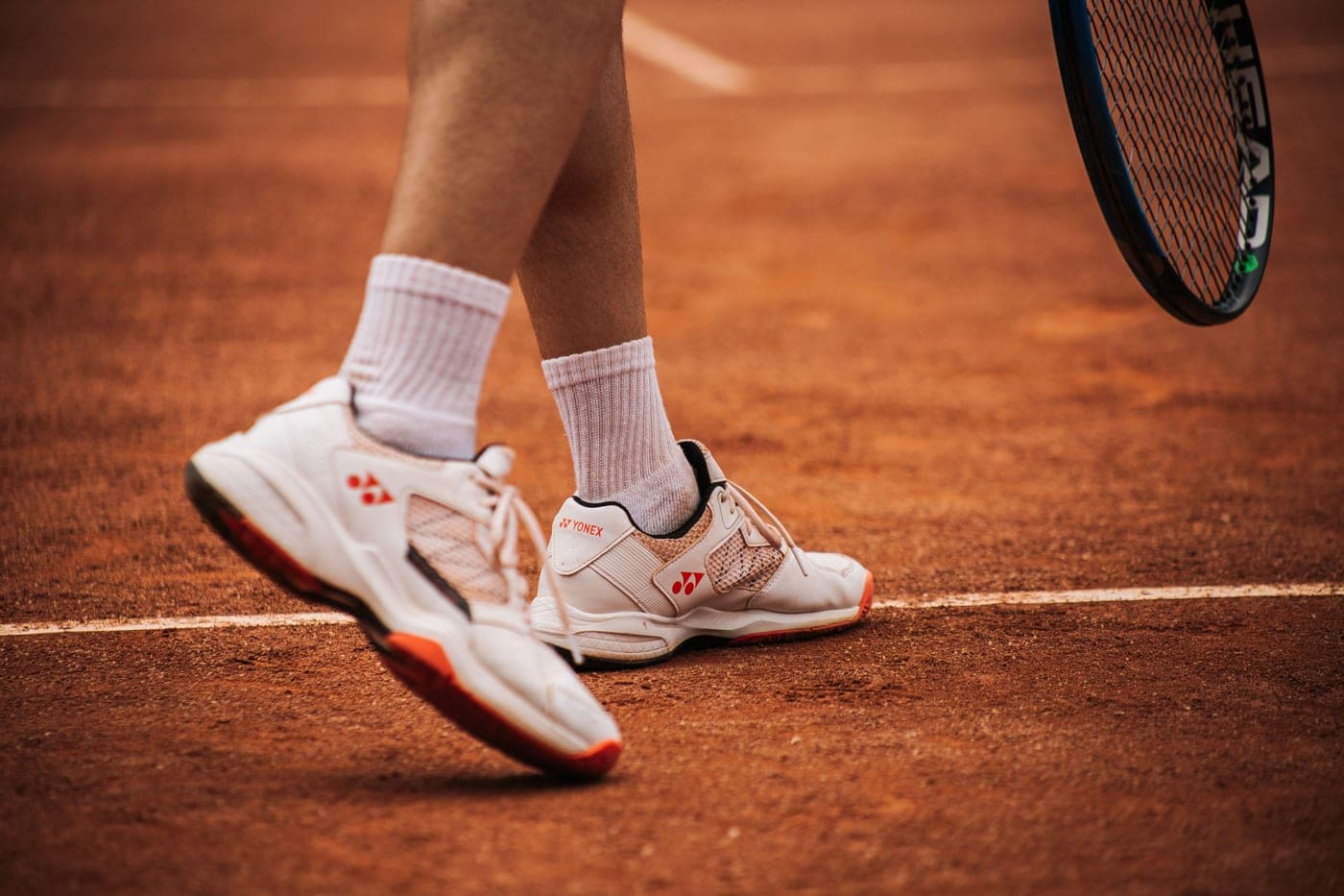A pair of court shoes positioned on painted court lines
