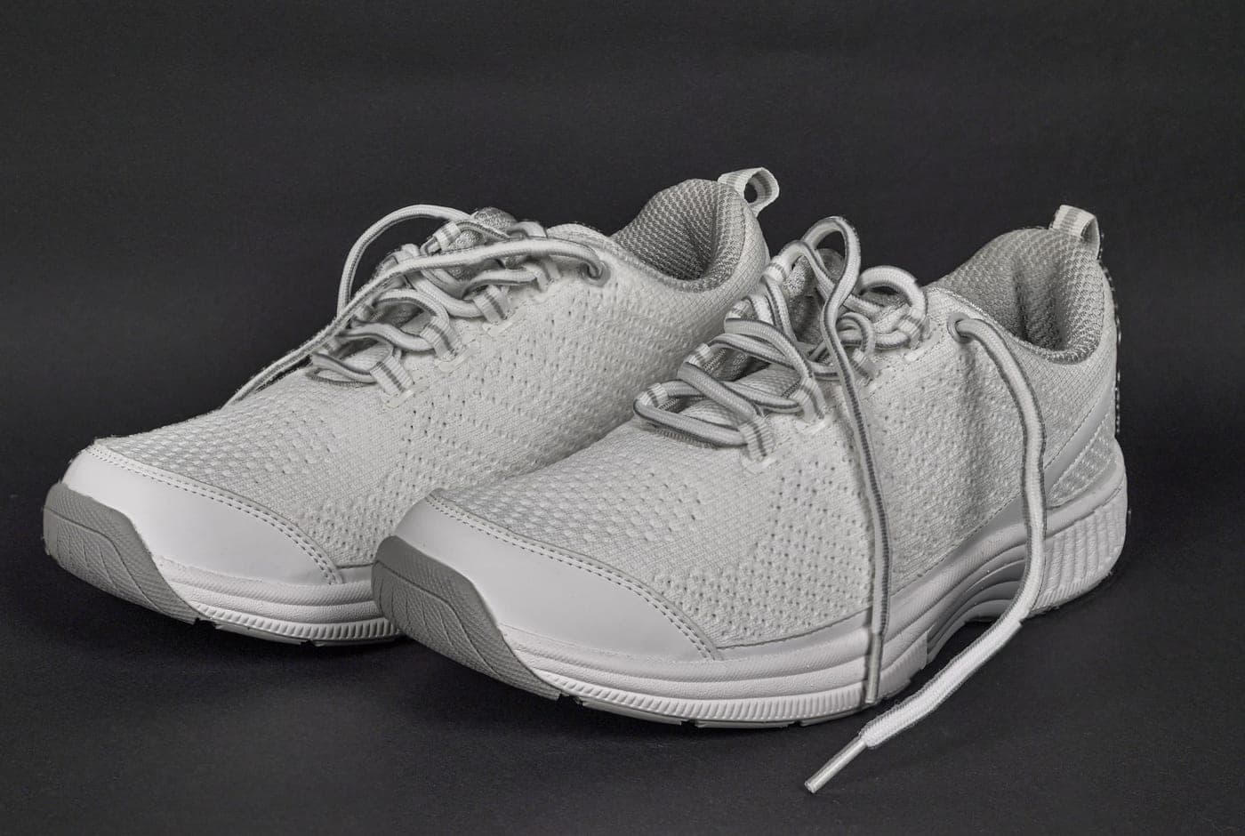 A pair of athletic shoes photographed in side profile
